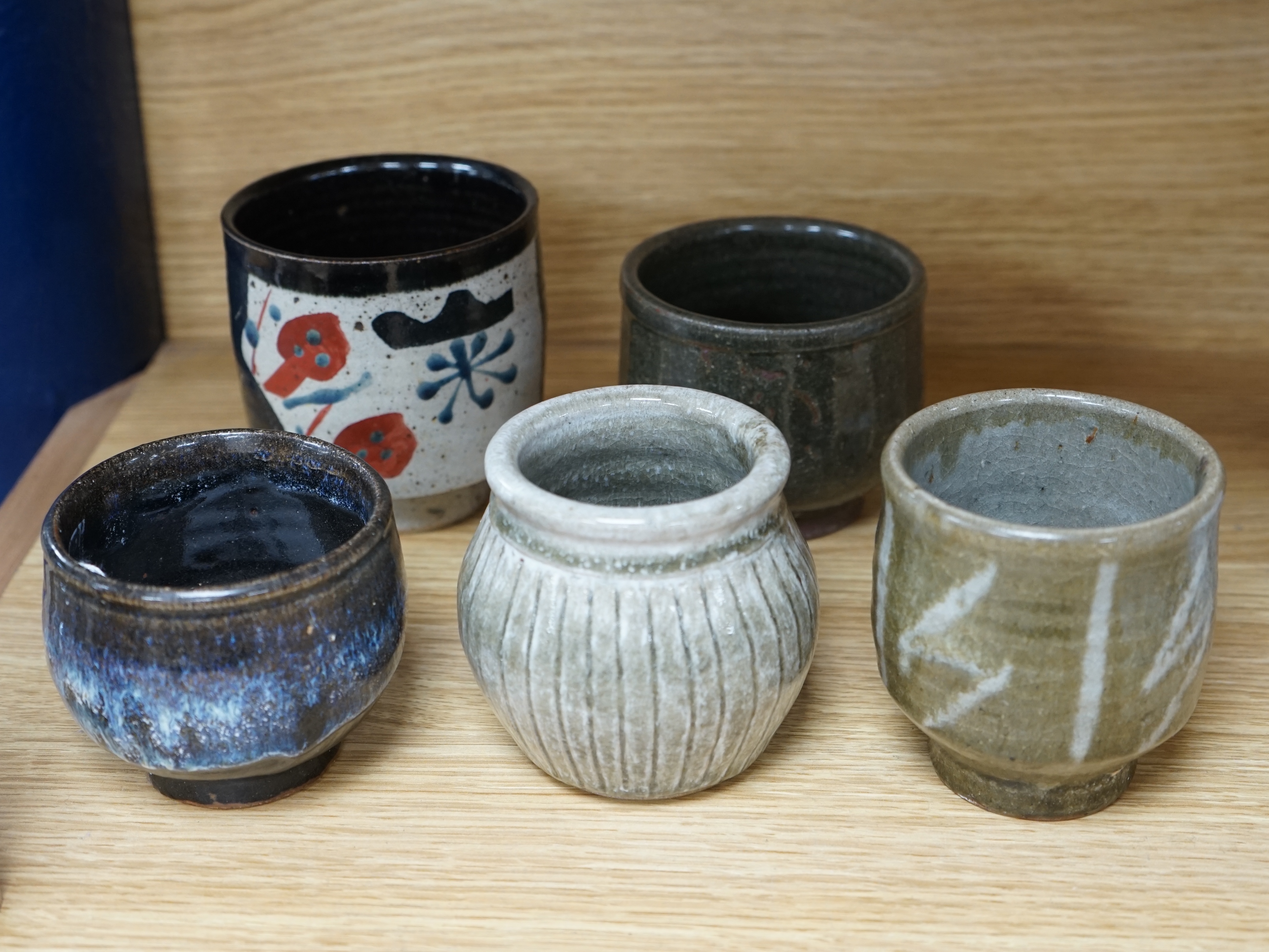 Five Japanese and European studio pottery yunomi, including an example by John Maltby, 10.5cm, together with another signed with a ‘P’ to the base. Condition - good.